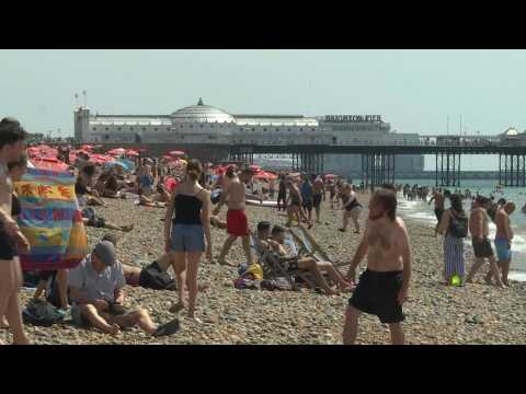 Britons flock to Brighton beach as UK breaks heat record