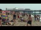Britons flock to Brighton beach as UK breaks heat record
