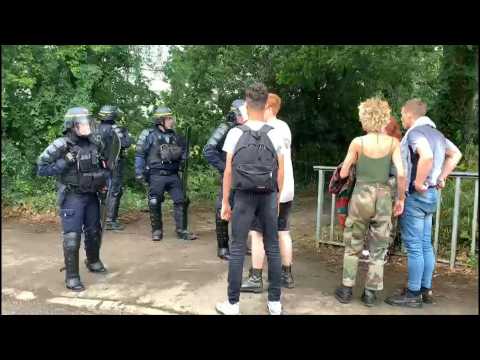 Party-goers leave the site of an illegal mass rave in France