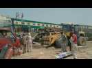 Mangled metal, bulldozers at site of deadly Pakistan train crash
