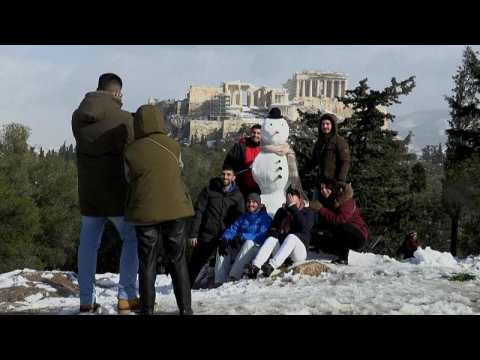Athens residents enjoy snowy day on the foothills of the Acropolis