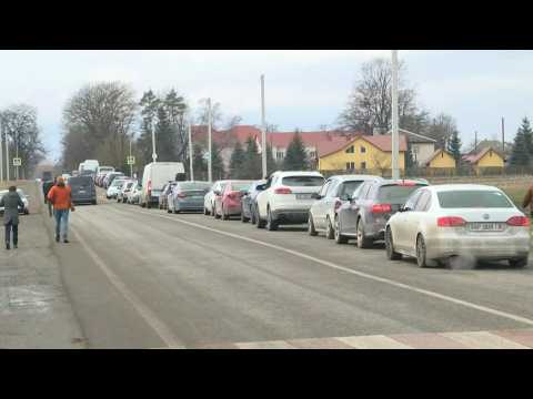 Cars line up on the Ukrainian side of the Ukraine-Poland border