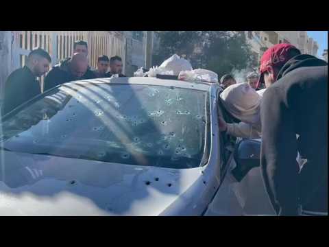 Palestinians look at bullet-ridden vehicle after Israel raid kills 3 in WB