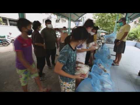 Unemployed people prepare food for those affected by Covid-19 in Bangkok