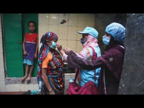 Volunteers distribute masks in Dhaka to prevent covid-19 infections