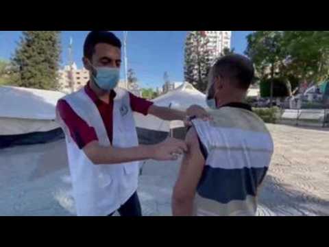 Palestinians receive COVID-19 vaccine in Gaza city