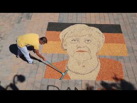 An artist makes a mosaic of Merkel in Kosovo
