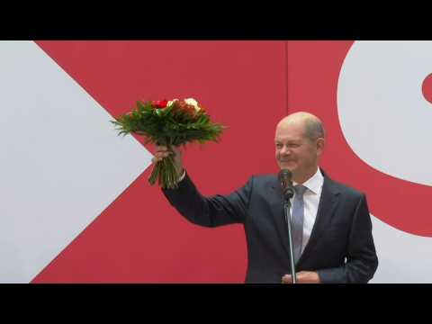 Olaf Scholz receives flowers after Germany's Social Democrats win election