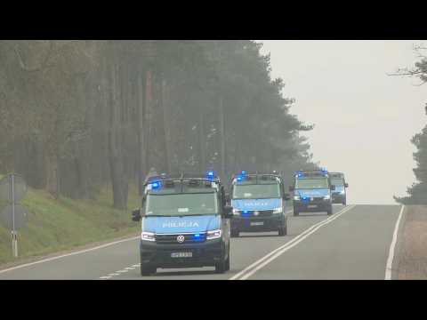 Police vans at checkpoint of entrance to emergency zone near Polish-Belarusian border