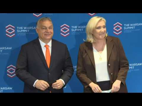 Hungarian PM Orban and French far-right presidential candidate Le Pen arrive at Warsaw conference