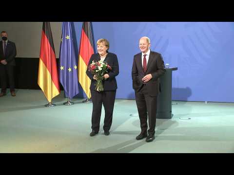 Handover between Angela Merkel and new German chancellor Olaf Scholz