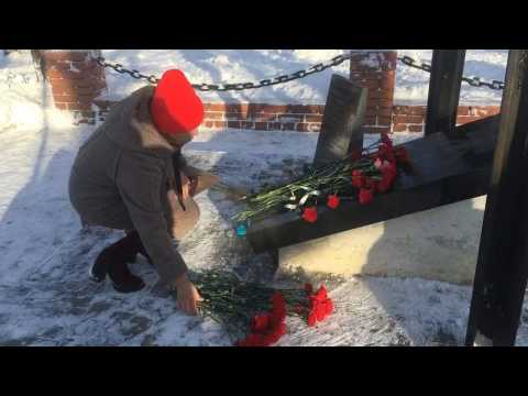 People lay flowers at memorial to rescuers after deadly accident in Siberian coal mine