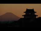 Sunset over Japan's Sekiyado Castle and Mount Fuji