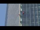 French urban climbers scale building in Frankfurt to raise awareness about climate change