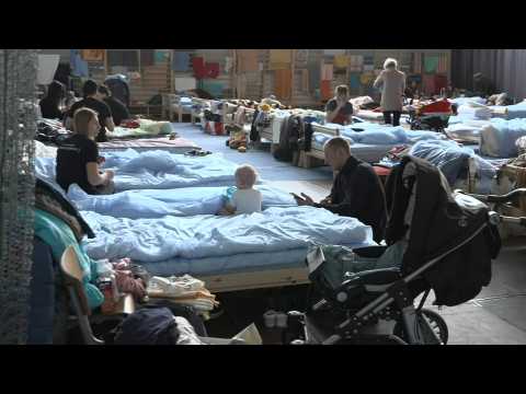 Refugees from Ukraine rest in a shelter after entering Poland