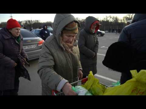 People receive humanitarian aid after fleeing besieged city of Mariupol