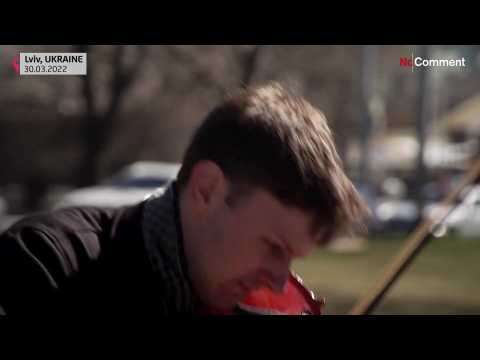 Street musician plays for Lviv residents as the city tries to keep up its spirit