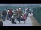 Ukrainian refugees fleeing shelling arrive in Poland