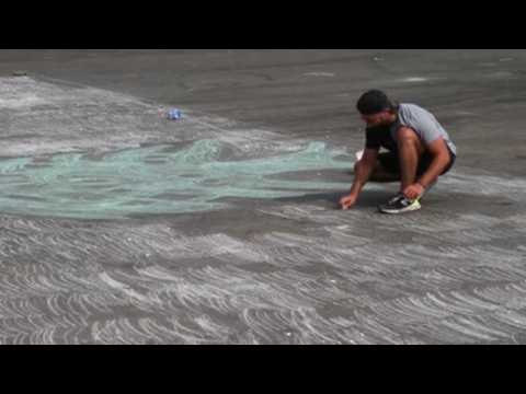 A Lebanese man tries to break Guinness record for drawing with chalk on street