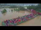 Mass evacuation by boat bridge in flood-hit Chinese villages
