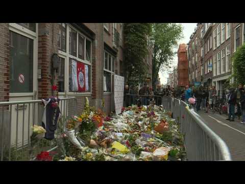 People lay flowers at site where Dutch crime reporter was shot
