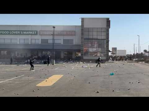 South African police fire rubber bullets to disperse looters