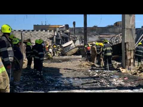 Rescue workers clear rubble after deadly missile attack on mall in Ukraine