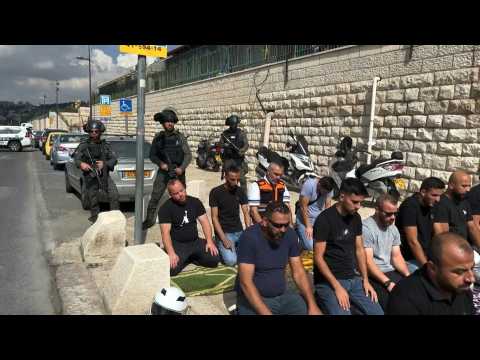 Palestinians make Friday Noon prayers in the street