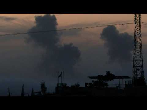 Smoke rises and rockets land in northern Gaza, seen from Israel
