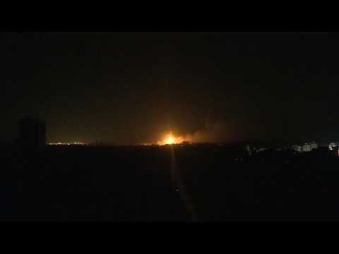 Flares and explosions over Gaza City night sky