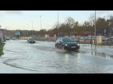 Cars crawl along water-logged roads in flood-hit northern France