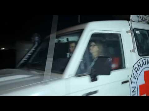 Released hostages cross Rafah to Egypt aboard Red Cross convoy
