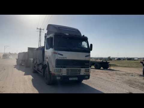 Trucks carrying humanitarian aid enter the Gaza Strip via the Rafah crossing with Egypt