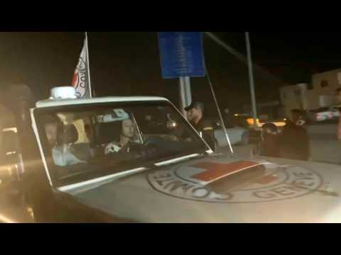 Two released hostages seen on board Red Cross convoy crossing Rafah