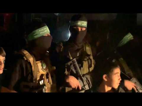 Hamas gunmen prepare to hand over hostages to Red Cross in Khan Yunis