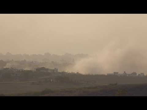 Damaged houses and smoke seen in Gaza as sun sets on day 24 of war