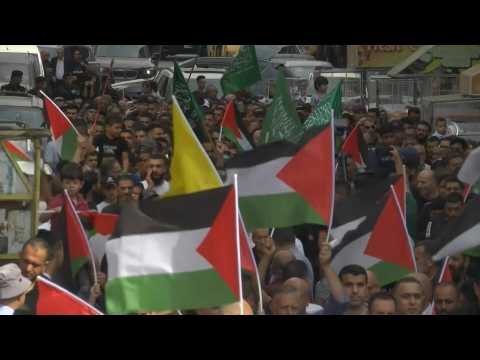 Palestinians rally in Ramallah in support of Gaza, holding Hamas flags