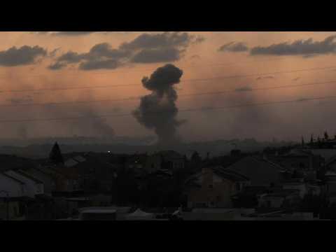 Smoke billows over northern Gaza at sunset