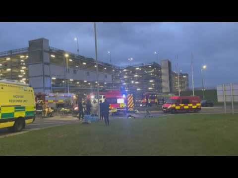 Firefighters and police at Luton Airport after car park fire