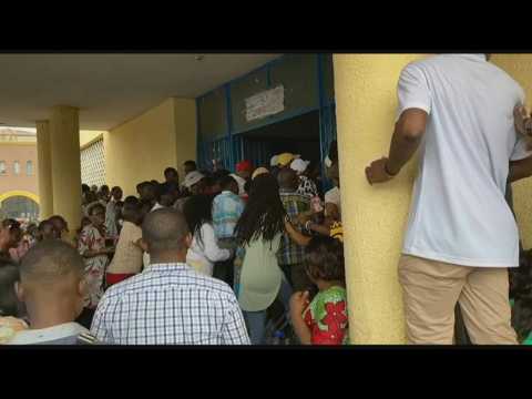 Voters force door of polling center amid delays in DR Congo elections