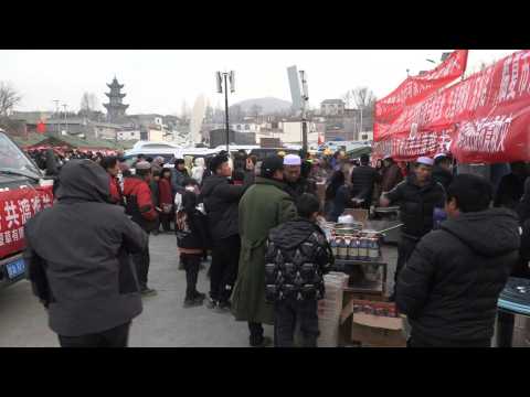 People receive food at relief camp after deadly China quake