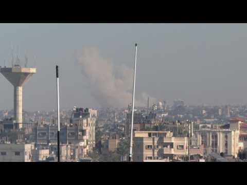 Smoke billows over Khan Yunis following Israeli strikes, seen from Rafah