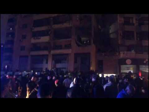 People gather in the street at site of explosion in Beirut's southern suburbs