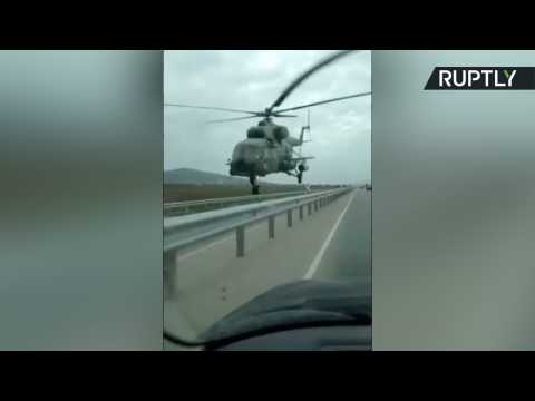 Military Helicopter Passes Just Several Feet Over Motorists on Highway