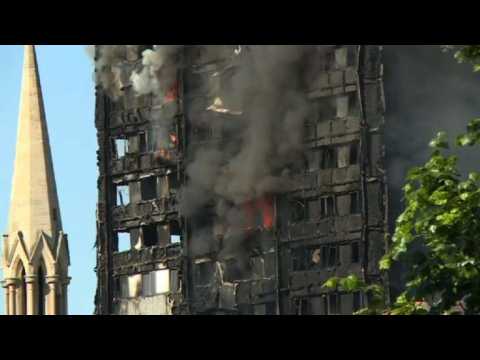 London fire: debris continues to fall from burning tower block
