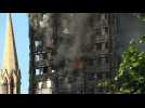 London fire: debris continues to fall from burning tower block