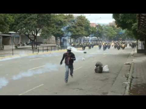 Police on motorbikes chase down protesters in Caracas