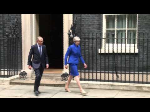 Theresa May leaves Downing St to meet Queen
