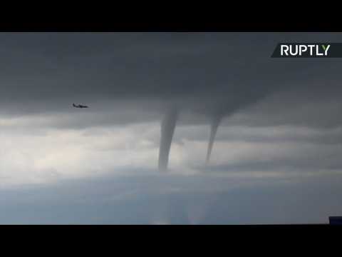 Pilot Flies Right by Three Water Tornados on Black Sea