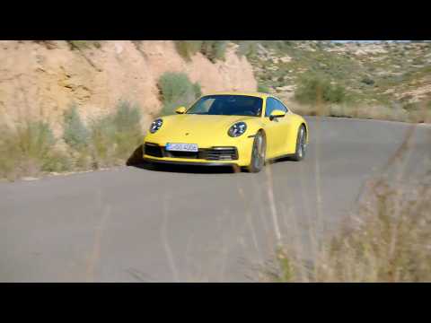 The new Porsche 911 Carrera S in Racing Yellow on the Country Road